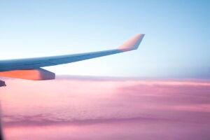 Commercial airliner taking off into a bright blue sky